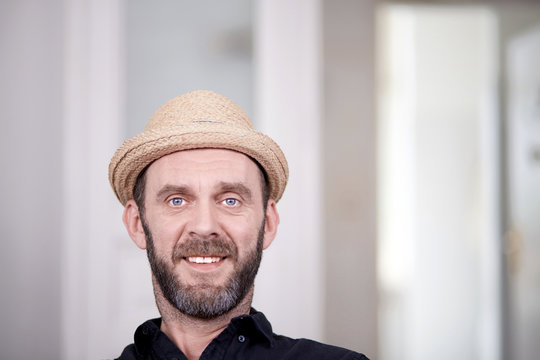 Portrait of friendly looking hipster with stray hat