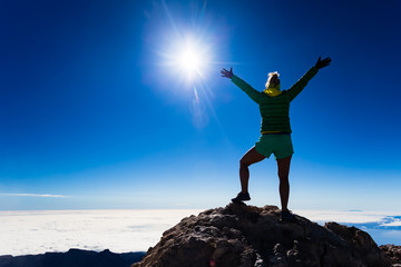 Woman climbing success silhouette on mountain top