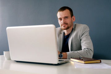 Successful businessman in jacket at work