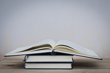 Old book on wood desk,soft focus.