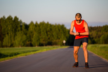 Man running on country road and training