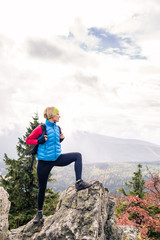 Woman hiking in autumn mountains and woods