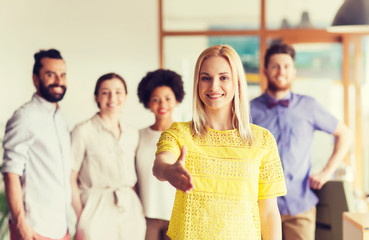 woman making handshake over creative office team