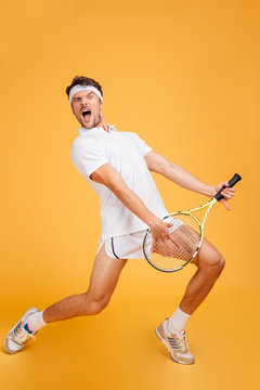 Man tennis player with racket singing and imitating playing guitar