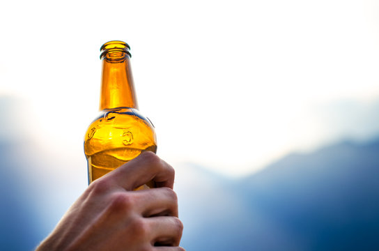 Bottle of beer. Natural background. Man hand´s keep a bottle of beer. Alcohol drink.