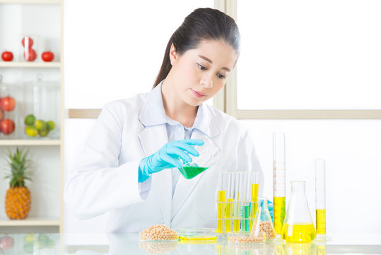 Asian female scientist testing gmo soya for human health