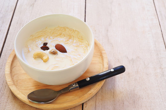 Close up of vermicelli Kheer or vermicelli pudding with vermicelli, milk and almond in a white bow