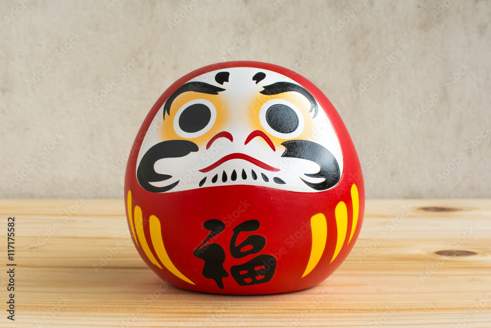 Wall mural Daruma doll japanese symbolise on wood table