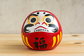 Daruma doll japanese symbolise on wood table