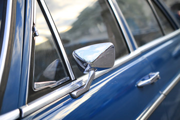 Vintage car detaill. Window and rear mirror.