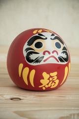 Daruma doll japanese symbolise on wood table