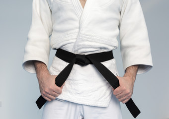 Martial arts Master tightening black belt