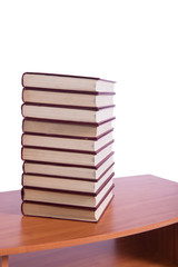 Stack of books arranged the office desk