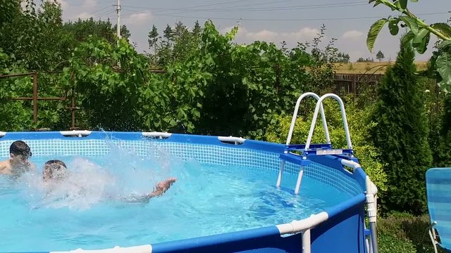Swimming pool. Little girl jumping into the water in pool. Slow motion. HD