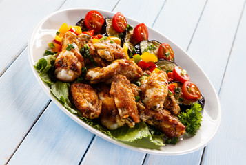 Grilled chicken wings and vegetables