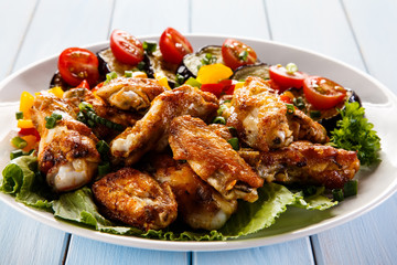 Grilled chicken wings and vegetables