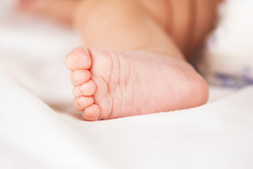 Obraz na płótnie Canvas Foot of a baby girl