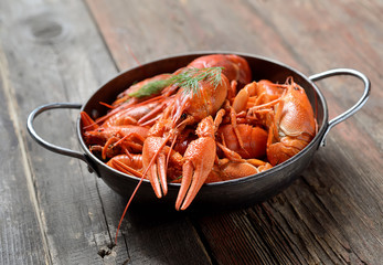 boiled crawfish in a plate  on a wooden background
