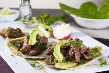 Mexican taco gourmet accompanied by avocado