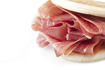 Italian prosciutto crudo ,raw ham leg sliced on white