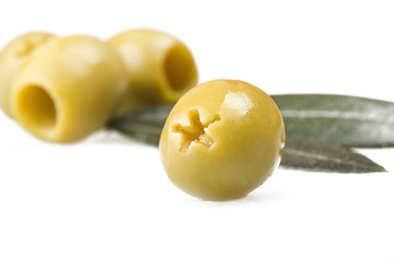 Pitted green olives close up on the white