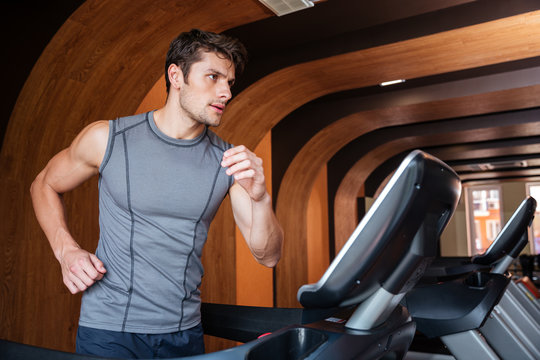 Man Athlete Running On Treadmill In Gym