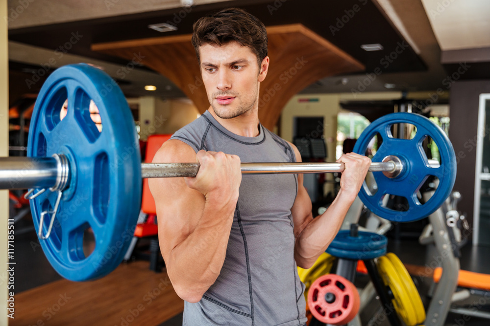 Sticker Man athlete working out with barbell in gym