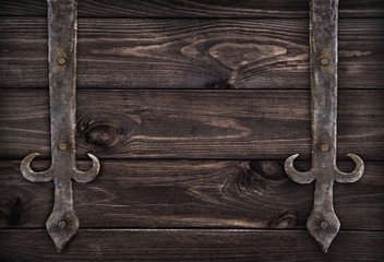 Forged metal elements on dark wooden doors