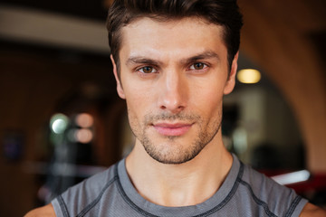 Handsome young fitness man in gym