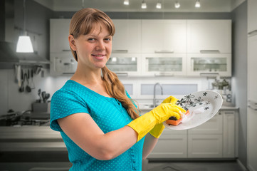 Housewife woman washing dishes in kitchen