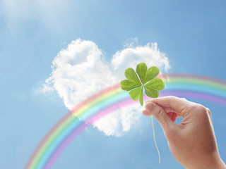 holding clover hand rainbow heart cloud