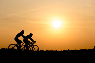 Plakat Silhouette of cycling on sunset background