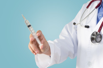 Female doctor or physician holding hypodermic syringe