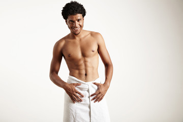 Fototapeta premium young latin man in white towel is smiling