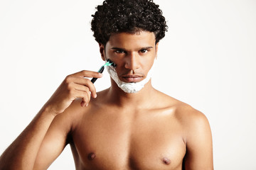 Fototapeta premium shaving man watching at camera with a serious face