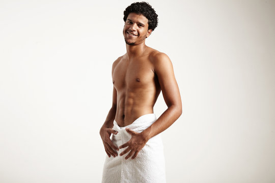 smiling man after shower wears white towel