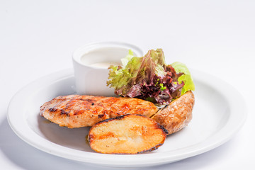 baked potatoes and steak on a white plate. Serving for the restaurant menu