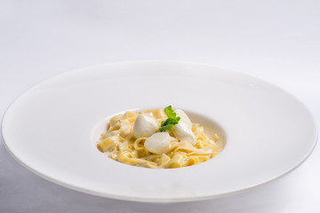 pasta with cream sauce in white plate. Serving for the restaurant menu