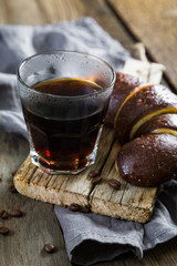 A glass of espresso and a croissant
