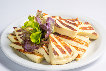 Grilled slices of cheese, served on a plate