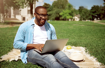 Positive man using laptop