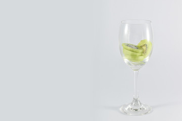 kiwi fruit in a glass wine isolated on white background.