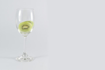 kiwi fruit in a glass wine isolated on white background.