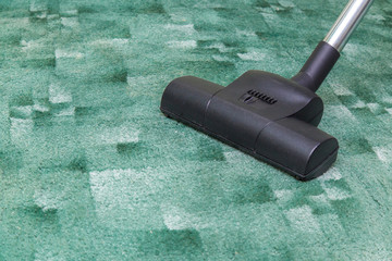 Professional vacuum cleaner brush frees the dirty carpet from dust. Early spring cleaning or...