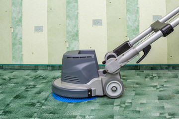 Green carpets chemical cleaning with professionally disk machine. Early spring cleaning or regular...