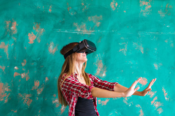 Fototapeta na wymiar Beautiful young woman playing game in virtual reality glasses