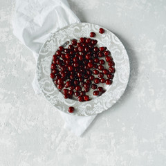 cherry at golden retro tray on concrete background