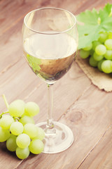White wine glass and grapes