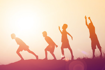 Fototapeta premium silhouette of a happy children and happy time sunset