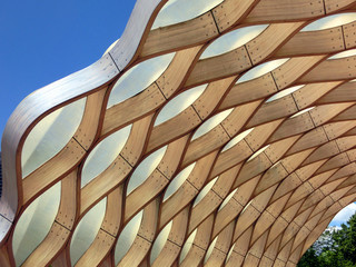 Wooden honeycomb geometric pattern against blue sky